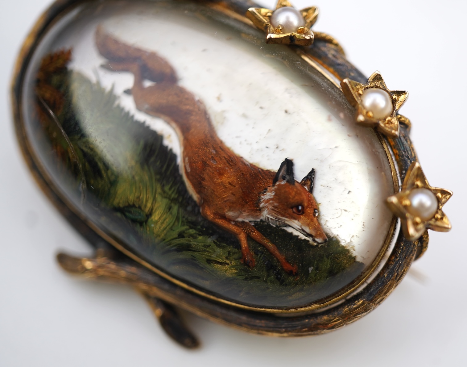 A reverse-carved and painted intaglio 'Essex crystal' brooch, late 19th century